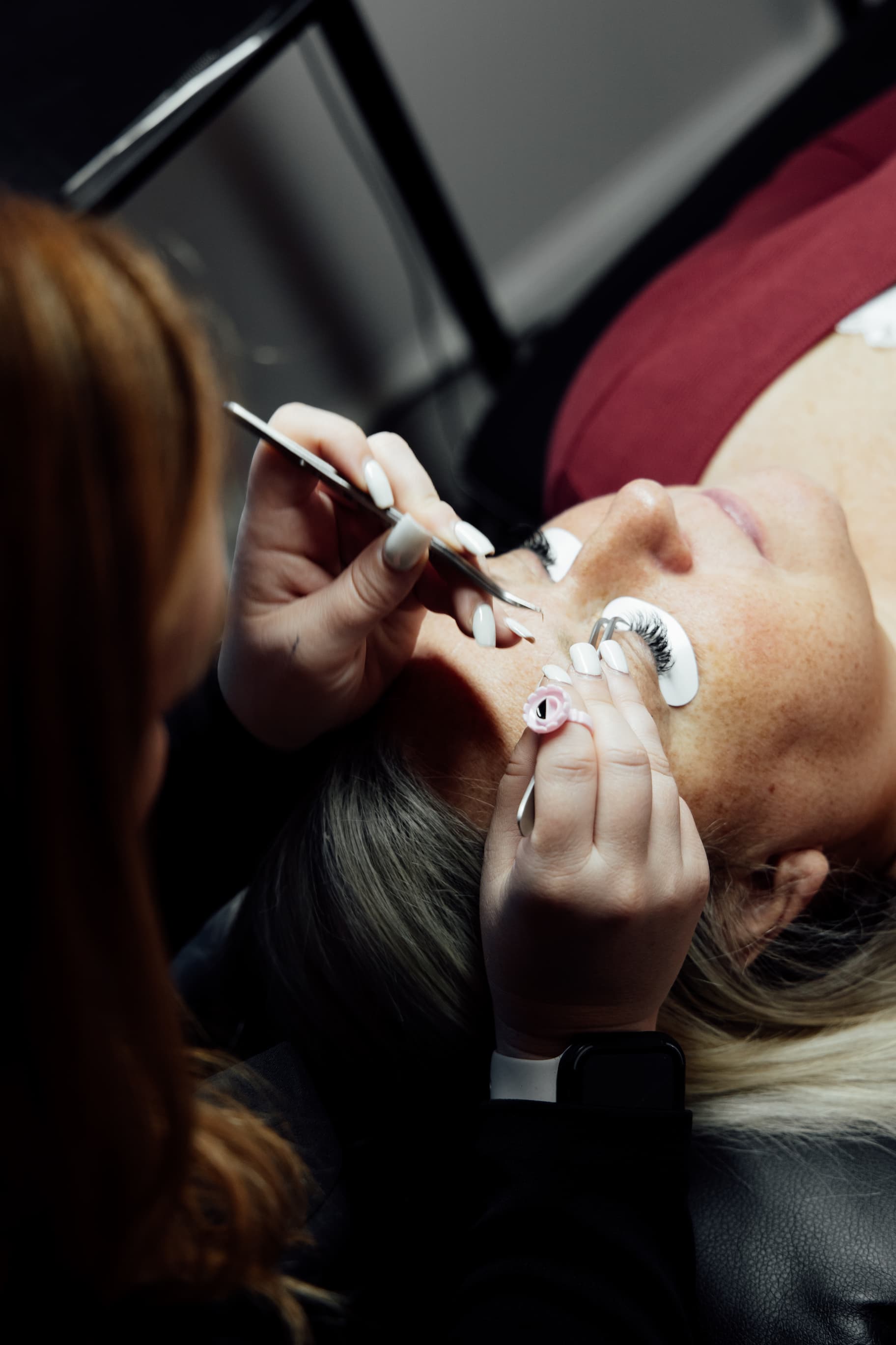 Close-up detail of eyelash extensions being applied at Total Vibe Salon & Studios